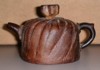 Clay tea pot which looks like a `meshed' screen.